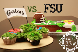 A green alligator cupcakes behind football field cake